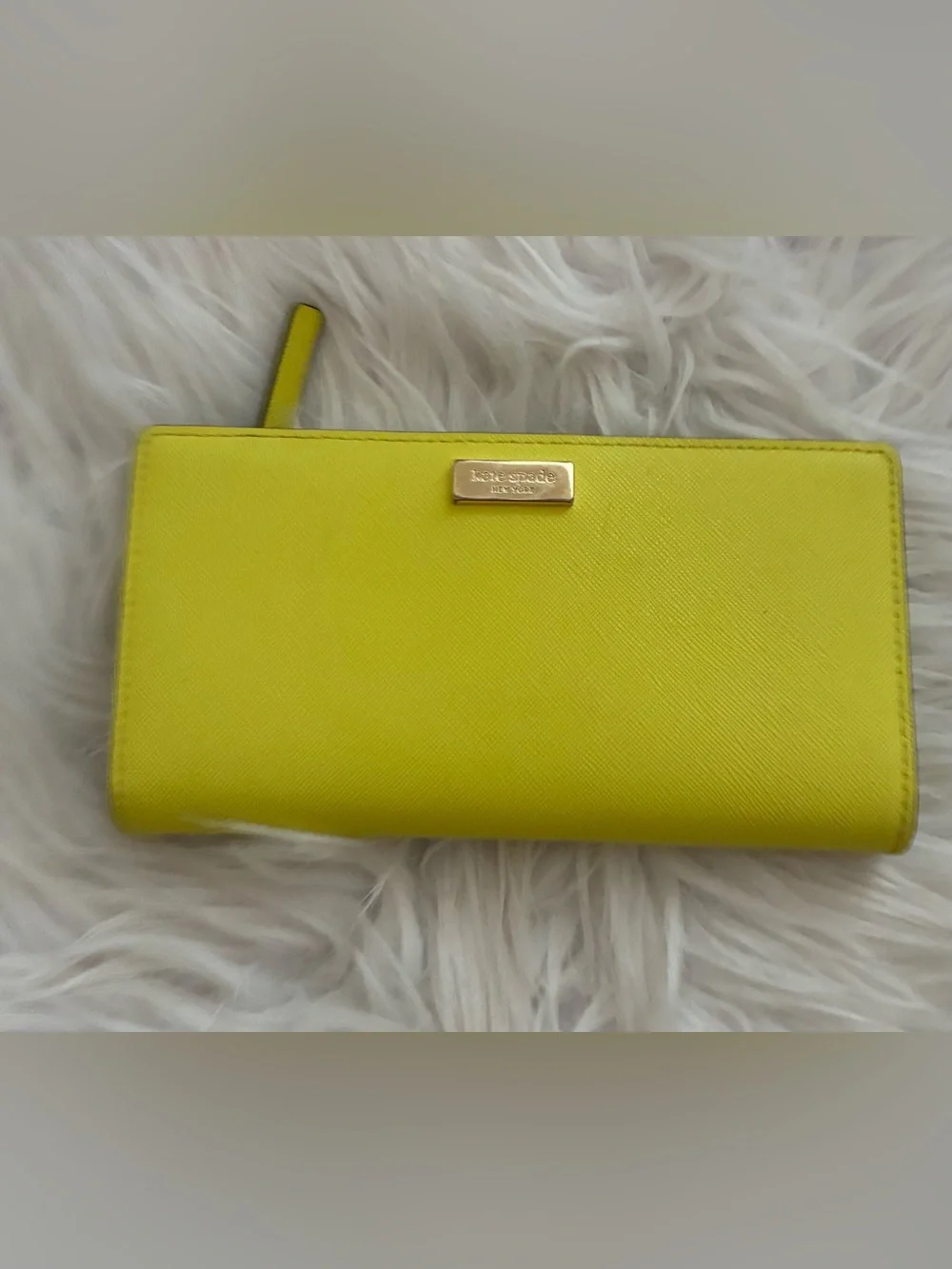 Lime green Kate Spade New York slim bifold wallet features multiple card slots